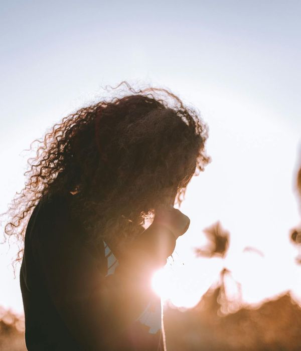 Person meditating peacefully in a calm, minimalist environment.